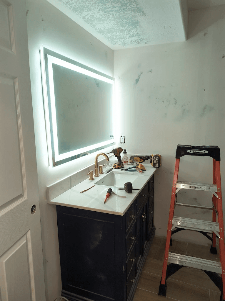 Backlit LED vanity mirror installed in a bathroom by High Desert Electric